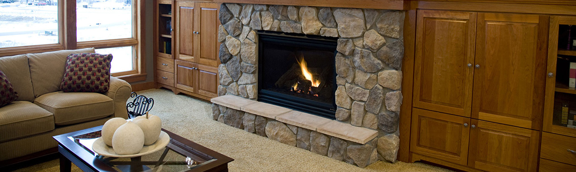 Gas burning fireplace with stone mantel