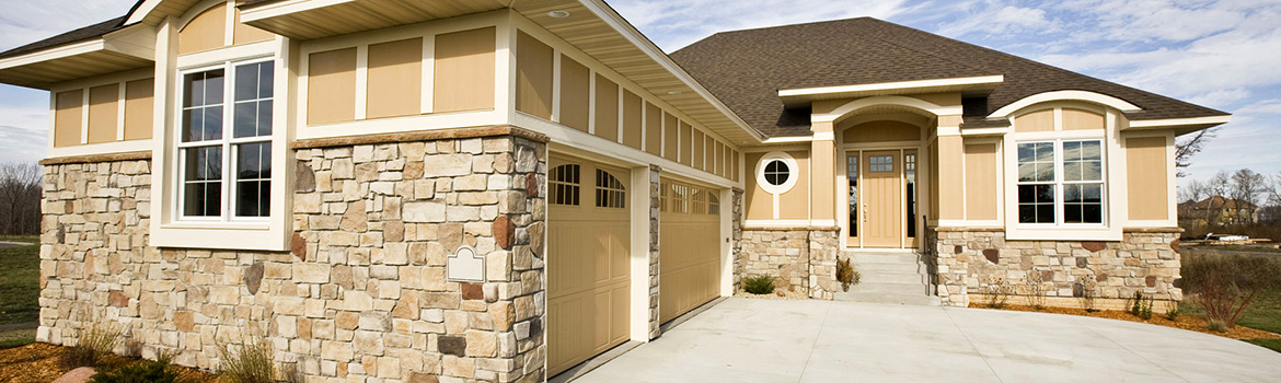 Assortment of patterns and colors of stone in the front and side of the house